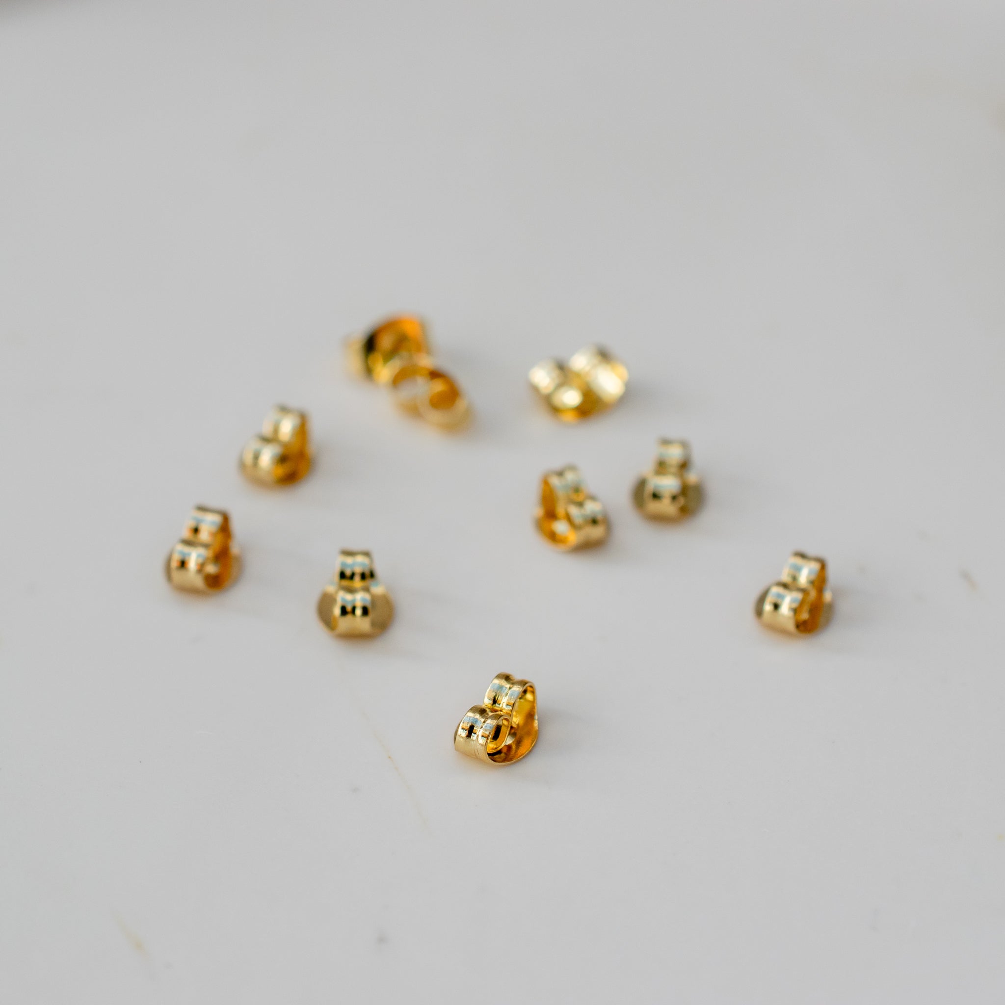 Goudkleurige RVS oorbel stoppers (5 paar) - Keelin Design